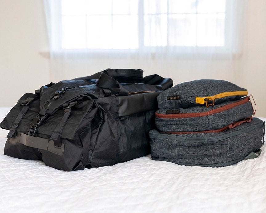 Hemp travel packing cubes next to a bag